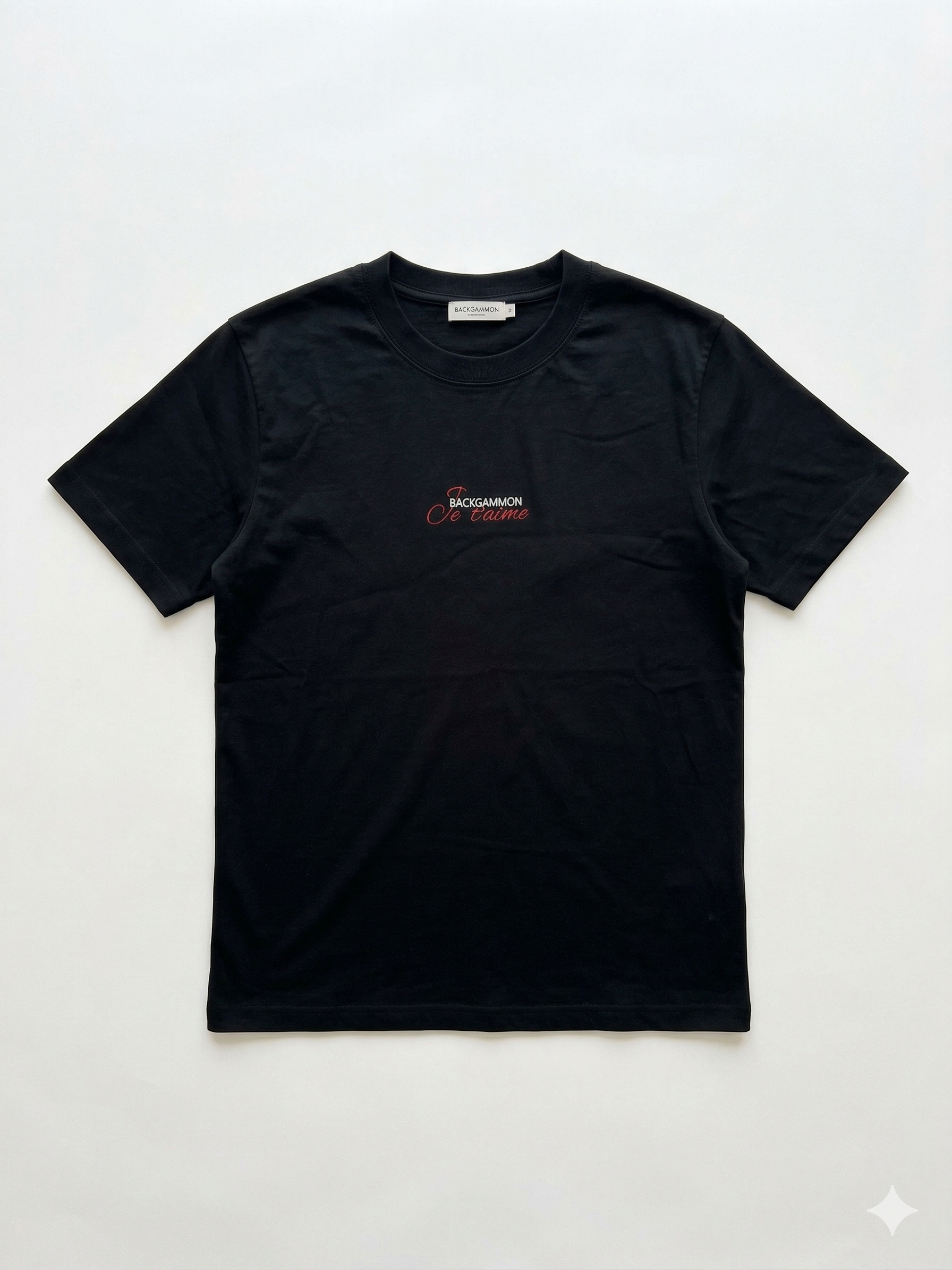 Flat lay of the black Backgammon Je t'aime T-shirt with embroidered red script logo on the chest