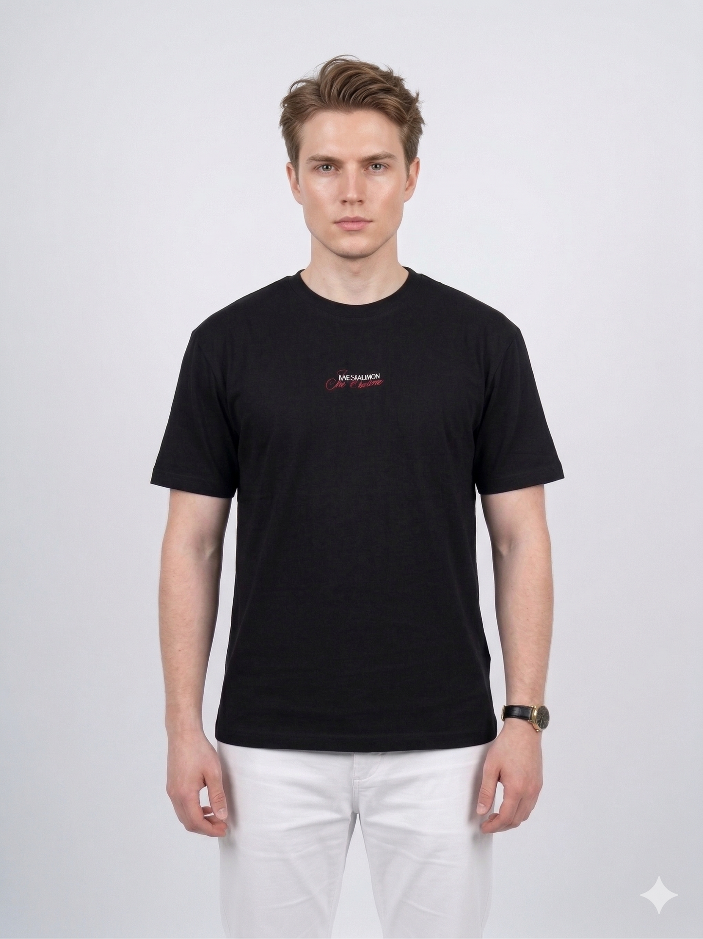 Model wearing the black Backgammon Je t'aime T-shirt with embroidered red script logo on the chest