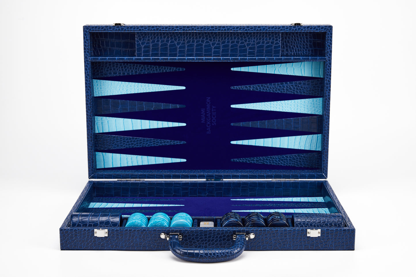 Open Midnight Navy crocodile-embossed backgammon case standing upright, showing empty navy and cyan playing field with Miami Backgammon Society logo and storage compartments