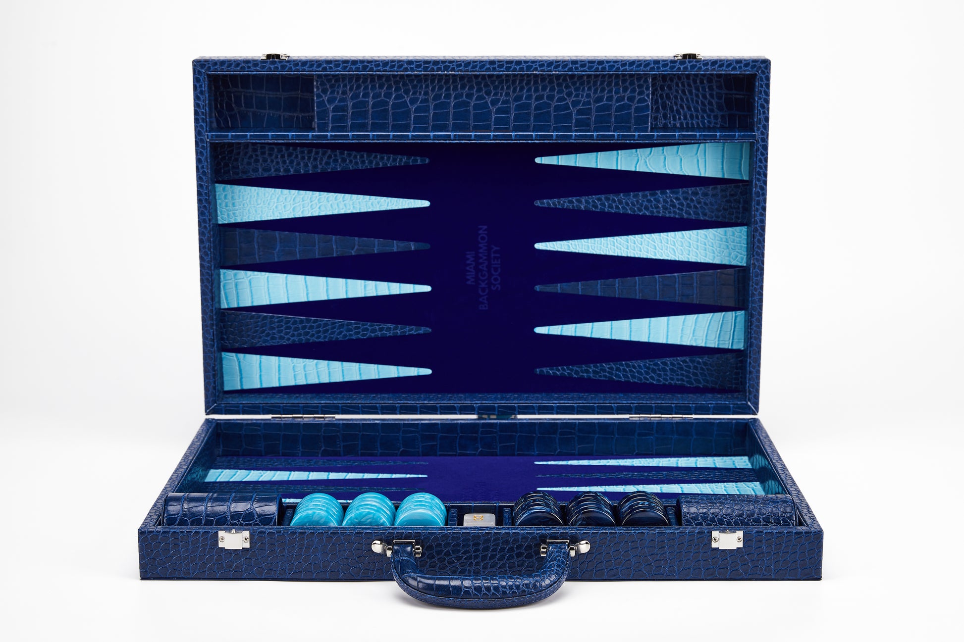 Open Midnight Navy crocodile-embossed backgammon case standing upright, showing empty navy and cyan playing field with Miami Backgammon Society logo and storage compartments