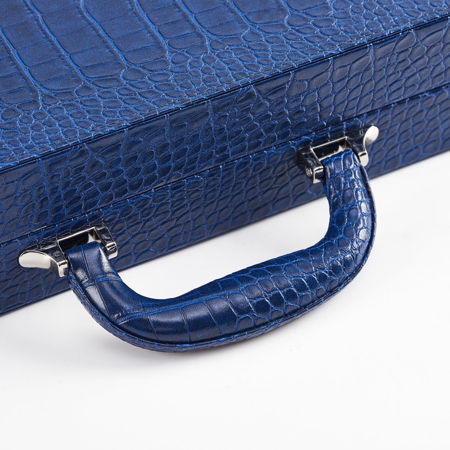 Close-up of the crocodile-embossed carry handle and silver clasps on the Midnight Navy backgammon case