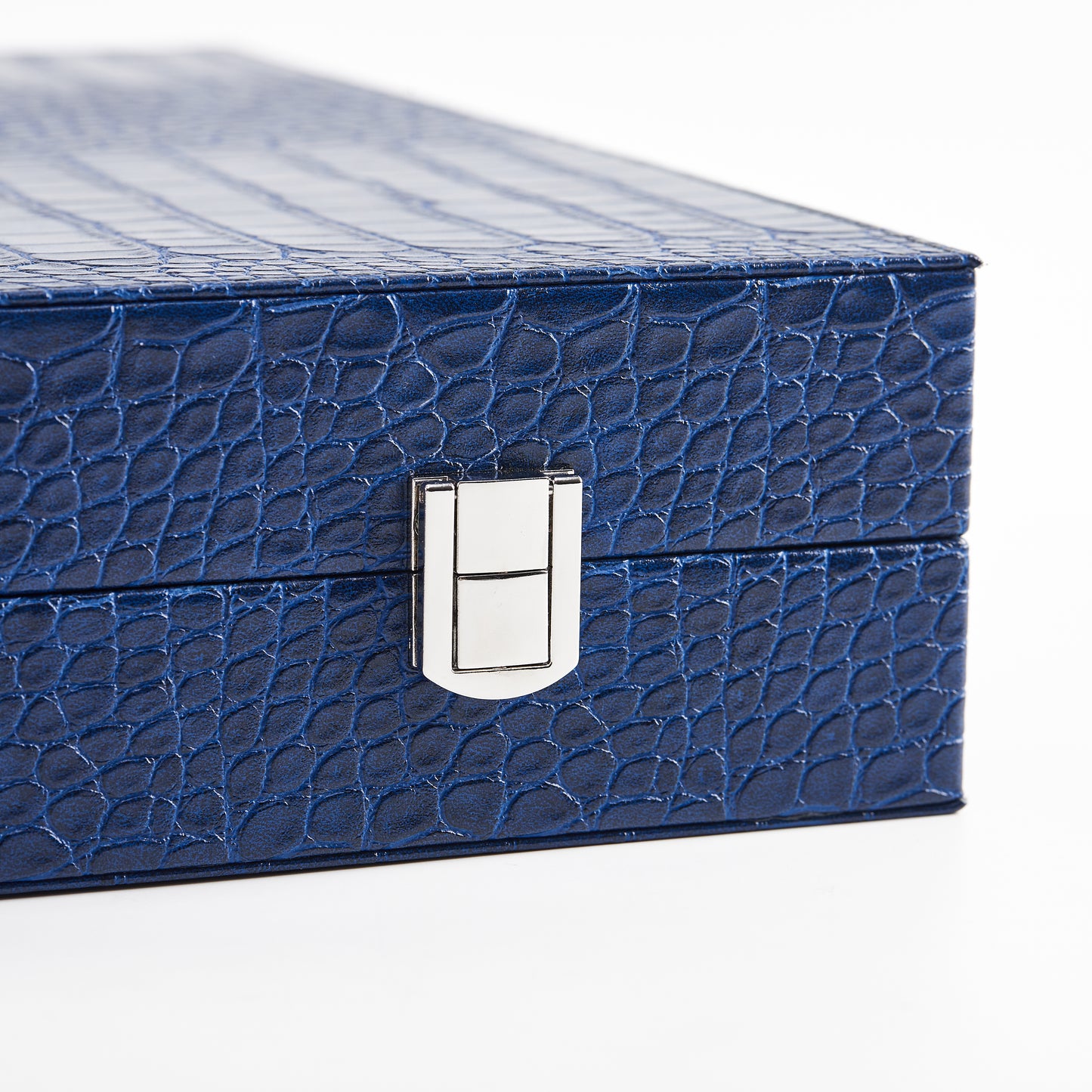 Close-up of the silver latch closure on the Midnight Navy crocodile-embossed backgammon case
