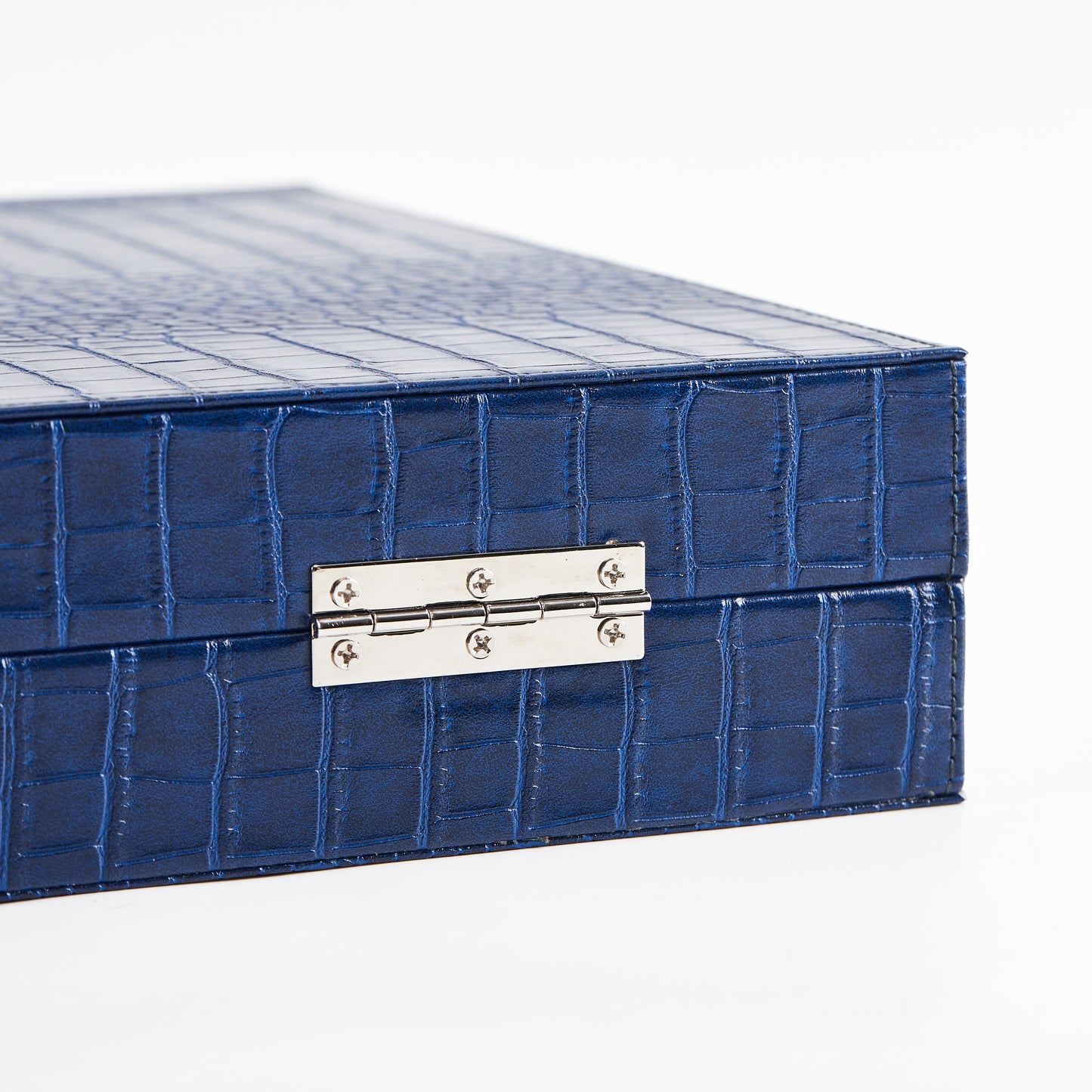 Close-up of the metal hinge on the closed Midnight Navy crocodile-embossed backgammon case