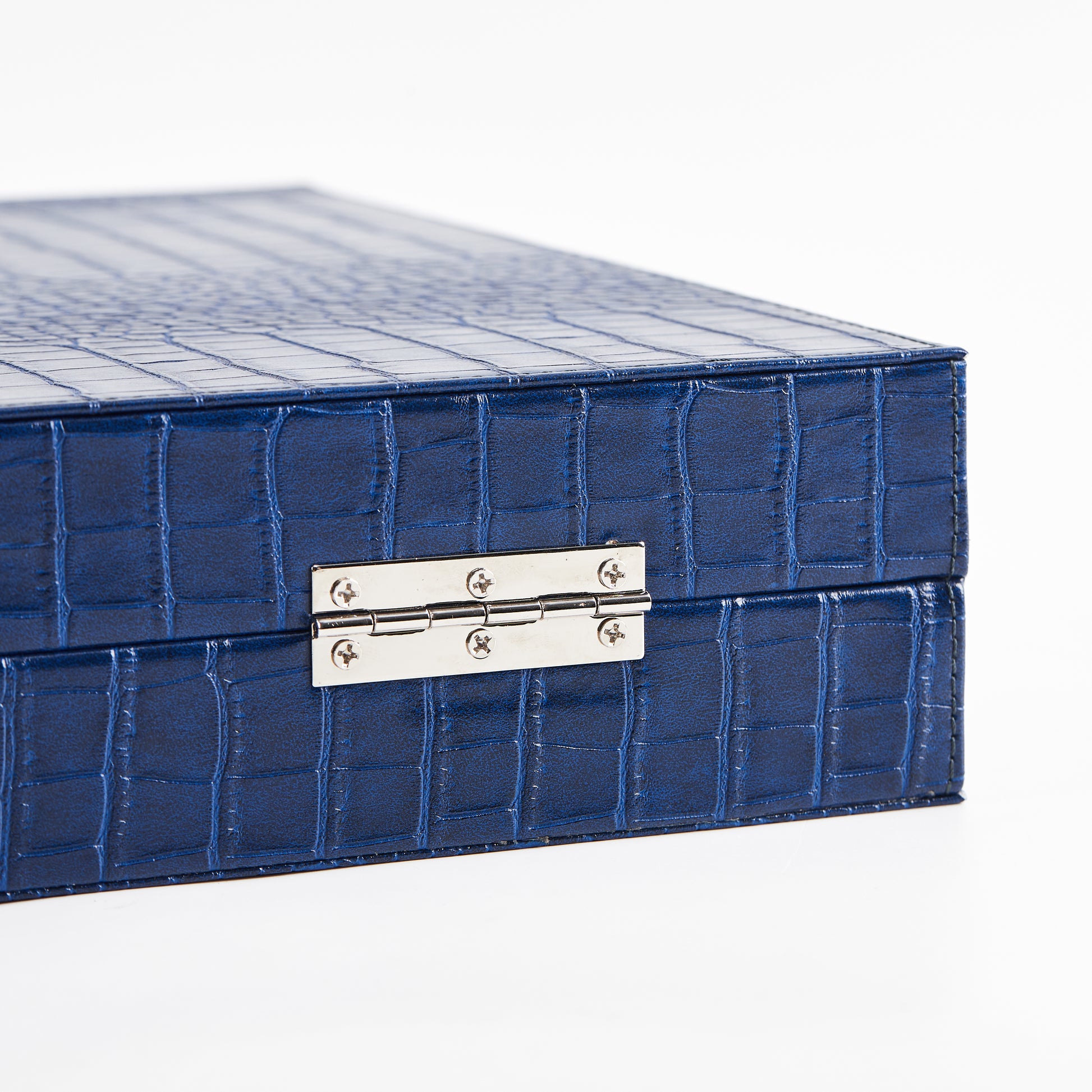 Close-up of the metal hinge on the closed Midnight Navy crocodile-embossed backgammon case