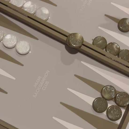 people playing backgammon on the miami backgammon club beige board