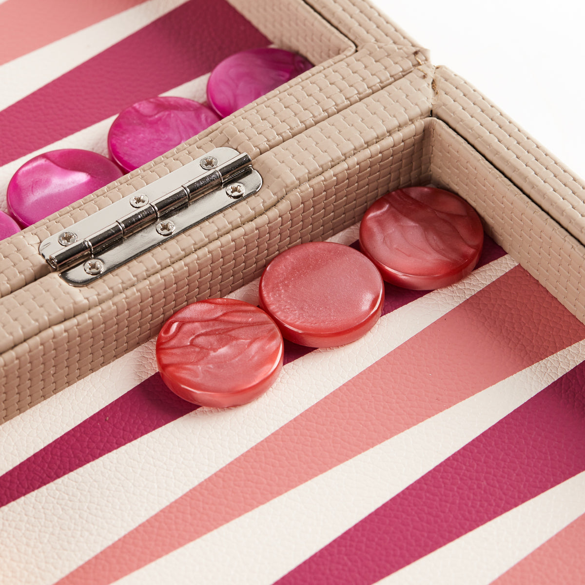 Close-up of magenta and coral pearlescent checkers either side of the hinge