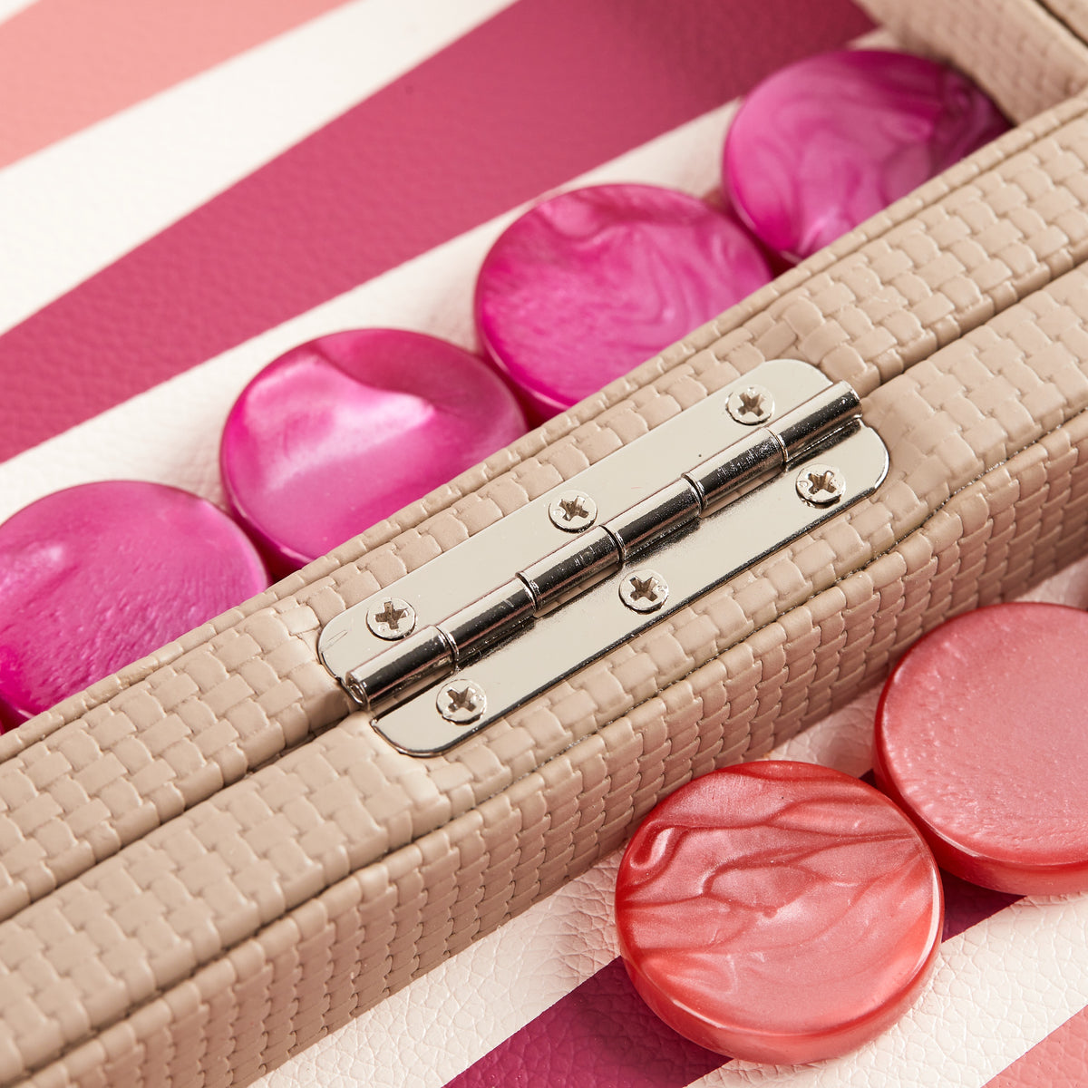 Close-up of pink and magenta playing points on the cream field
