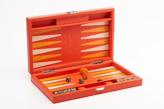 Orange backgammon board open at an angle, showing ivory and golden points
