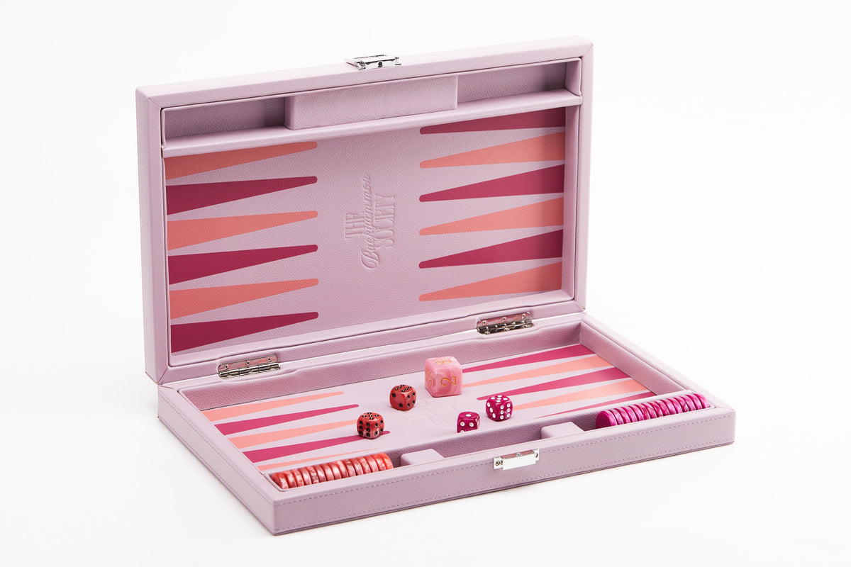 Pink backgammon board open at an angle, showing coral and fuchsia points