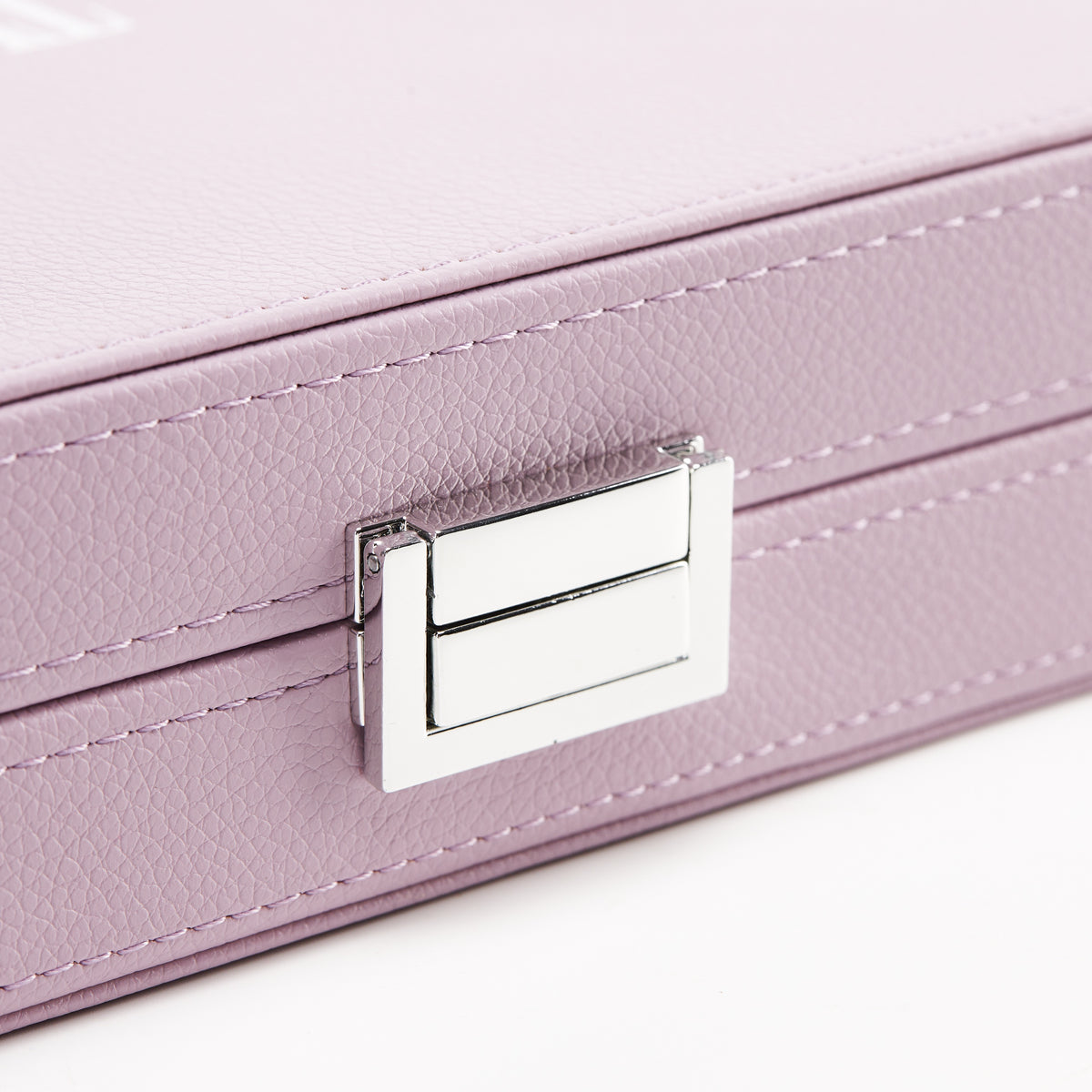 Close-up of the silver-tone clasp on the blush leather case