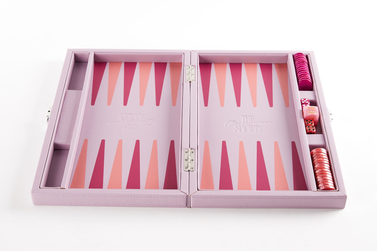 Pink backgammon board open flat at an angle, fully set up